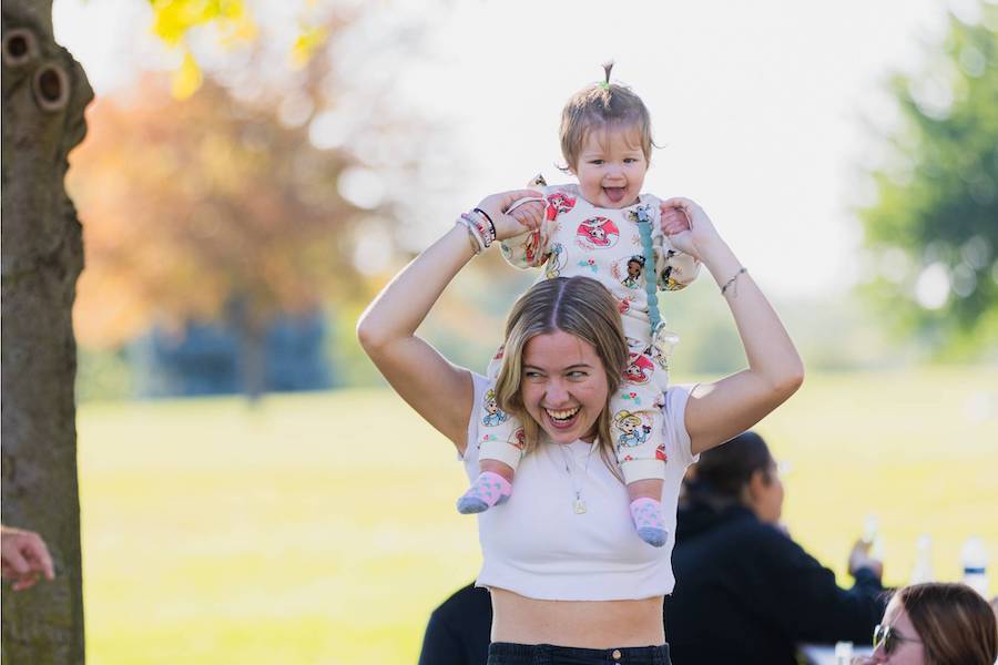 A student having fun with a sibling at Family Weekend